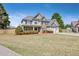 Attractive two-story home with a two-car garage, front porch, and manicured lawn at 8450 Sundial Ct, Johns Creek, GA 30024