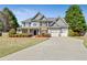 Charming home featuring stone accents, a two-car garage and manicured front lawn at 8450 Sundial Ct, Johns Creek, GA 30024