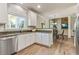 Modern kitchen with granite countertops and stainless steel dishwasher overlooking dining area at 8450 Sundial Ct, Johns Creek, GA 30024