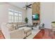 Inviting living room featuring stone fireplace, large windows and hardwood flooring at 8450 Sundial Ct, Johns Creek, GA 30024
