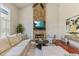 Bright living room with stone fireplace, large windows and hardwood flooring at 8450 Sundial Ct, Johns Creek, GA 30024