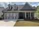 Charming home featuring a stone and gray plank facade, dormer windows, and a two-car garage at 122 Airmont Dr, Sharpsburg, GA 30277