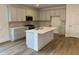 Modern kitchen with shaker cabinets, an island with bar seating, and stainless steel appliances at 122 Airmont Dr, Sharpsburg, GA 30277