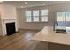 Bright living room featuring a fireplace, hardwood floors, and a seamless flow to the patio at 122 Airmont Dr, Sharpsburg, GA 30277