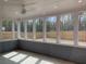 Relaxing screened porch with wooded views offering a versatile outdoor space for entertaining at 122 Airmont Dr, Sharpsburg, GA 30277