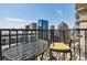 Private balcony with city views and black metal bistro set at 195 14Th Ne St # Ph206, Atlanta, GA 30309