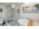 Bright bathroom showcases a soaking tub, separate shower with glass door, and modern lighting at 195 14Th Ne St # Ph206, Atlanta, GA 30309