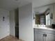 Modern bathroom with a vanity, a framed mirror, neutral tile and a door at 195 14Th Ne St # Ph206, Atlanta, GA 30309