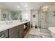 Bathroom showcasing double sinks, cabinets, soaking tub, and a glass shower with modern features at 195 14Th Ne St # Ph206, Atlanta, GA 30309