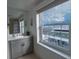 Beautiful bathroom featuring modern fixtures, a large window with city views, and stylish vanity at 195 14Th Ne St # Ph206, Atlanta, GA 30309