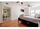 Bright bedroom featuring an adjacent bathroom and hardwood floors at 195 14Th Ne St # Ph206, Atlanta, GA 30309