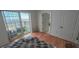 Bright bedroom featuring a private balcony with city views and hardwood floors at 195 14Th Ne St # Ph206, Atlanta, GA 30309