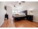 Bright bedroom featuring hardwood floors, ceiling fans, and a dark wood bedroom set at 195 14Th Ne St # Ph206, Atlanta, GA 30309