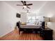 Bright bedroom featuring hardwood floors, ceiling fans, and a dark wood bedroom set at 195 14Th Ne St # Ph206, Atlanta, GA 30309