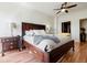 Bright bedroom featuring hardwood floors, ceiling fans, and a dark wood bedroom set at 195 14Th Ne St # Ph206, Atlanta, GA 30309