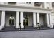 Elegant building exterior featuring large white pillars leading to an entryway with ornate hanging lamps at 195 14Th Ne St # Ph206, Atlanta, GA 30309