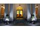 Night view of elegant building entryway featuring ornate hanging lamps, white pillars and stairs at 195 14Th Ne St # Ph206, Atlanta, GA 30309