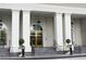 Elegant building exterior featuring golden entry doors, grand white pillars and stairs at 195 14Th Ne St # Ph206, Atlanta, GA 30309