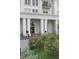 Elegant building exterior featuring large white pillars leading to an entryway, enhanced by beautiful landscaping at 195 14Th Ne St # Ph206, Atlanta, GA 30309