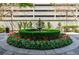 Beautiful courtyard featuring a circular flower bed, fountain, and lush greenery at 195 14Th Ne St # Ph206, Atlanta, GA 30309