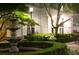 Courtyard garden with a stone fountain, lush landscaping, and elegant lighting at 195 14Th Ne St # Ph206, Atlanta, GA 30309