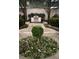 Outdoor kitchen in garden space with stainless grill, flower beds, and stone path at 195 14Th Ne St # Ph206, Atlanta, GA 30309