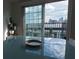 Modern dining area showcases a glass table with a view to the city skyline through a large glass door at 195 14Th Ne St # Ph206, Atlanta, GA 30309