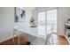 Bright dining area features a white dining table, a modern light fixture, and sliding door access to a balcony at 195 14Th Ne St # Ph206, Atlanta, GA 30309