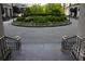 Exterior view of landscaped driveway with lush green spaces leading to the building at 195 14Th Ne St # Ph206, Atlanta, GA 30309