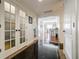 Hallway with gleaming black tile flooring and glass-paned doors, showcasing the home's design at 195 14Th Ne St # Ph206, Atlanta, GA 30309