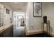 Hallway with black granite floors, framed art and access to the kitchen beyond at 195 14Th Ne St # Ph206, Atlanta, GA 30309
