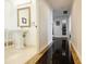 Hallway with marble flooring and an adjacent powder room with pedestal sink, creating a stylish transition space at 195 14Th Ne St # Ph206, Atlanta, GA 30309