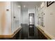 Elegant hallway with glossy black tile floor and white doors, leading to other rooms at 195 14Th Ne St # Ph206, Atlanta, GA 30309