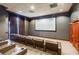 Private home theater featuring tiered seating, large viewing screen, and dark brown accents at 195 14Th Ne St # Ph206, Atlanta, GA 30309