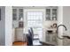 Modern kitchen featuring granite counters, glass cabinets, and stainless steel faucet fixture at 195 14Th Ne St # Ph206, Atlanta, GA 30309