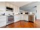 Bright kitchen with stainless steel appliances, custom cabinetry, and granite countertops at 195 14Th Ne St # Ph206, Atlanta, GA 30309