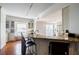 View of kitchen breakfast bar area with seating and adjacent living space with view at 195 14Th Ne St # Ph206, Atlanta, GA 30309