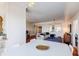 Open-concept living area with hardwood floors, a stylish sofa, and a large mirror creating a bright atmosphere at 195 14Th Ne St # Ph206, Atlanta, GA 30309