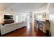 Open-concept living room with hardwood floors flowing into the dining area and kitchen bar at 195 14Th Ne St # Ph206, Atlanta, GA 30309