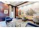 Stylish lounge featuring a long sofa, comfortable chairs, dark trim, and an outdoor mural at 195 14Th Ne St # Ph206, Atlanta, GA 30309
