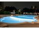 Night view of sparkling pool with comfortable lounge seating and lush landscaping at 195 14Th Ne St # Ph206, Atlanta, GA 30309