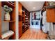 Spacious walk-in closet with custom built-in shelving, drawers, wood floors and hanging storage space at 195 14Th Ne St # Ph206, Atlanta, GA 30309