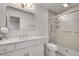 Clean bathroom with shower, grab bars, and vanity with ample lighting at 1674 Executive Park Ne Ln, Atlanta, GA 30329