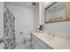 Bright bathroom with a framed mirror above the sink and a shower/tub with floral curtain at 1674 Executive Park Ne Ln, Atlanta, GA 30329