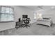 Spacious bedroom with a desk, comfortable chair, and large windows with neutral blinds at 1674 Executive Park Ne Ln, Atlanta, GA 30329