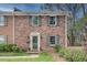 Charming brick home with a well-manicured front yard and symmetrical windows and shutters at 1674 Executive Park Ne Ln, Atlanta, GA 30329