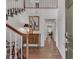 Inviting foyer with hardwood floors, staircase with white railing, and view into hallway at 1674 Executive Park Ne Ln, Atlanta, GA 30329