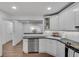Bright kitchen featuring white cabinets, modern appliances, and a breakfast bar at 1674 Executive Park Ne Ln, Atlanta, GA 30329