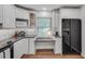 Well-lit kitchen featuring black appliances, light counter tops and white cabinets at 1674 Executive Park Ne Ln, Atlanta, GA 30329
