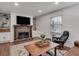 Bright living room with hardwood flooring features a stone fireplace, built-in shelving, and neutral décor at 1674 Executive Park Ne Ln, Atlanta, GA 30329